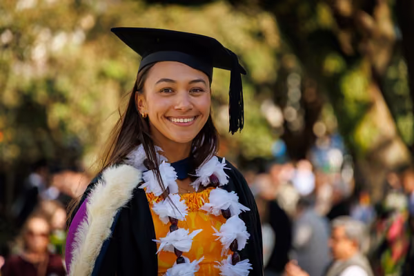 girl in graduation gear smiling at camera