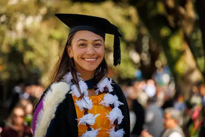 girl in graduation gear smiling at camera