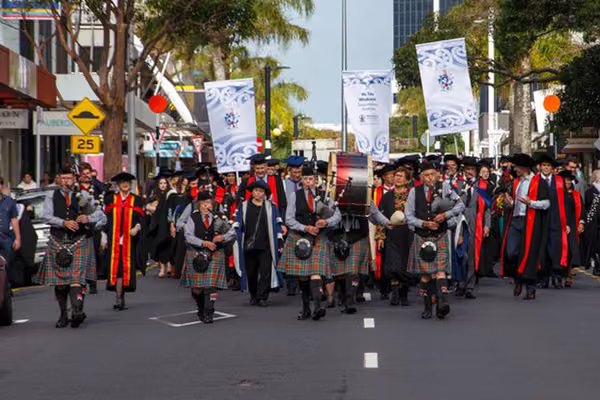 Procession ceremony walking down street in Auckland.