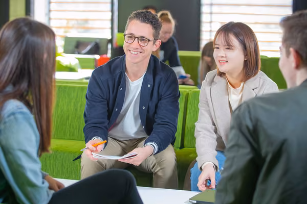 Four people talking in a public lounge
