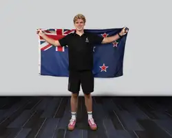 man holding New Zealand flag behind him