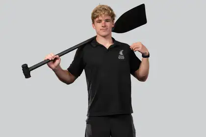 man standing looking at camera holding paddle