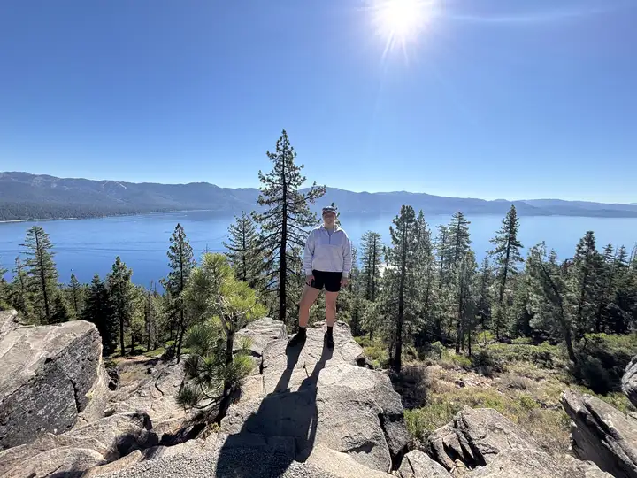 woman standing in front of beautiful mountain scenery