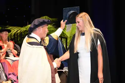 woman being capped by chancellor at graduation ceremony