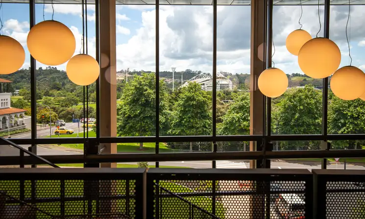 Large pendant lights hanging above the main staircase in the Innovation Complex