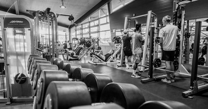 Black and white photo of students sharing the gym facilities