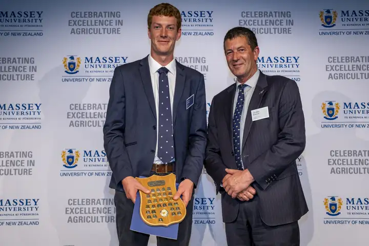 James Gurin holding the Sally Hobson Award alongside Hon Mike Butterick, Associate Minister of Agriculture.