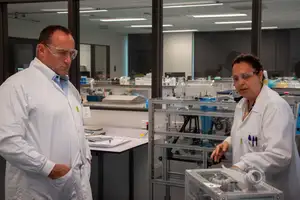 two people in lab coats in a lab