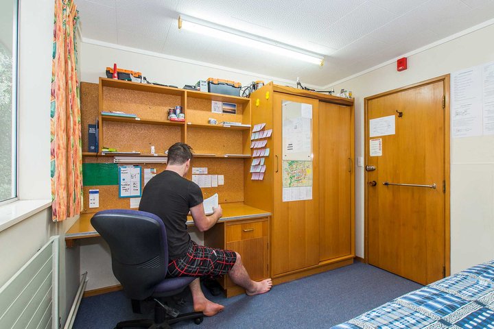 Student sitting at desk in Kiwitea bedroom