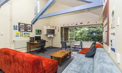 Kiwitea lounge with couches, coffee table, computer desk, TV and garden views
