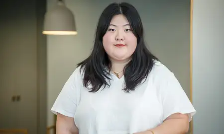 Hana Lee standing in front of white background.