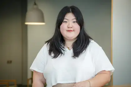 Hana Lee standing in front of white background.