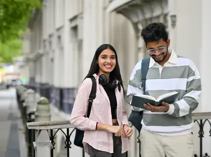 Student standing outside a building. Study with Massey as an international student.