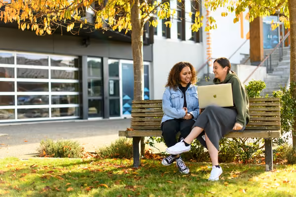 Future students chatting over a notebook computer
