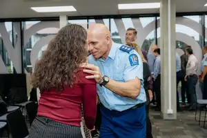 Waitematā District Māori Responsiveness Manager Inspector Todd Bartlett from New Zealand Police greets Massey staff after the blessing.
