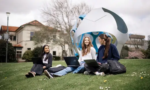 Group of students on Massey University manawatu campus lawn.