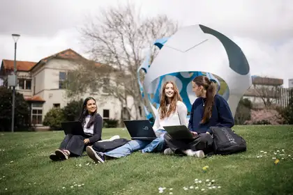 Group of students on Massey University manawatu campus lawn.