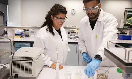 Massey student Akashdeep Beniwal in a lab on the Manawatū campus with a fellow student.