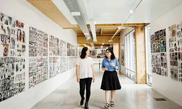 Two girls walking down corridor at Massey University