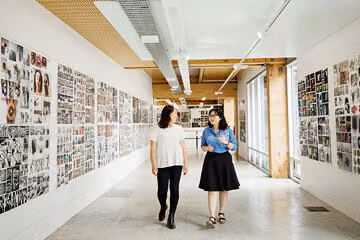 Two girls walking down corridor at Massey University