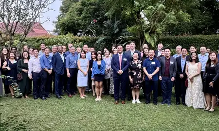 Massey alumni gathered outside with new students in Singapore.