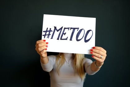 Woman holding 'Me Too' sign