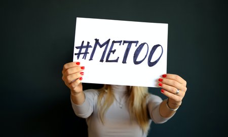Woman holding 'Me Too' sign