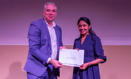 Mike Fenton presenting Dhanesha Nanayakkara with a certificate.