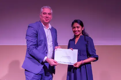 Mike Fenton presenting Dhanesha Nanayakkara with a certificate.