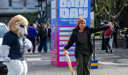 Woman in front of Open Days sign at 2023 Manawatu on campus Open Day.