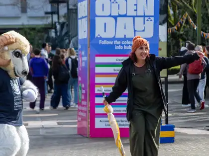 Woman in front of Open Days sign at 2023 Manawatu on campus Open Day.
