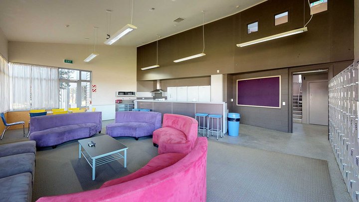 Matai, Miro, Tawa and Totara Halls' lounge area with a kitchenette and couches arranged in a semi-circle