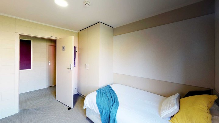 Matai, Miro, Tawa and Totara Halls' single bedroom with a bed and a wardrobe