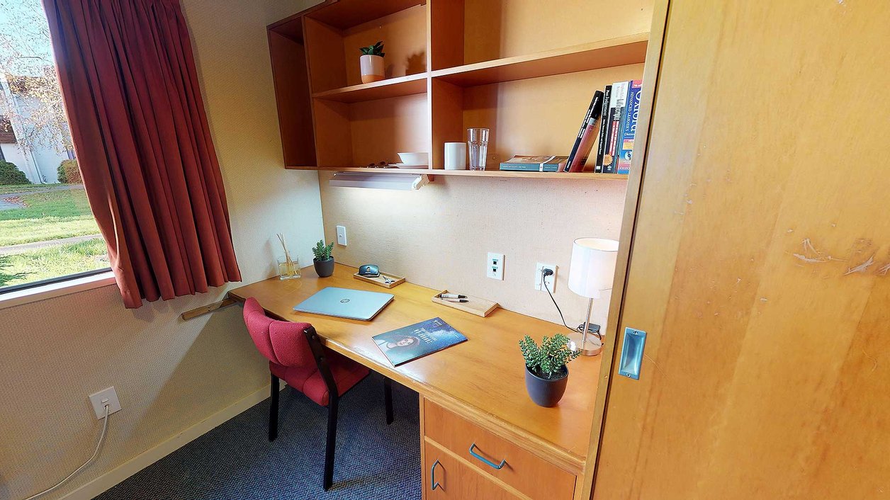 Interior of Ruahine and Tararua apartments' single bedrooms with built-in study desk and chair