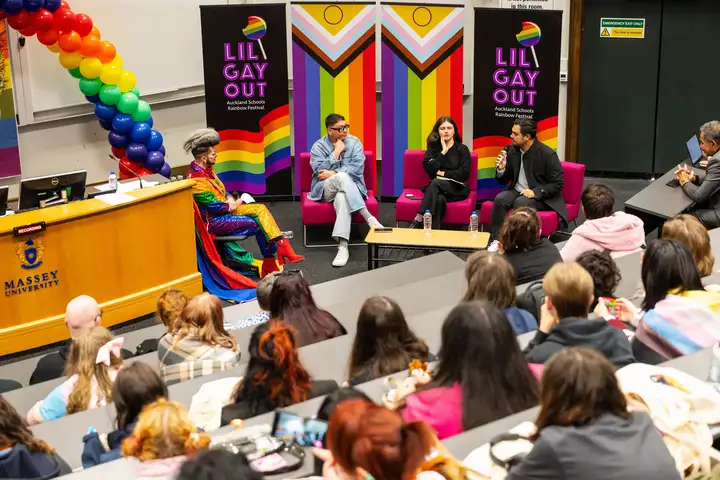 Panel discussion at Lil' Gay Out, with Hugo Grrl, Hāmiora Bailey, Chlöe Swarbrick and Dr Tere McGonagle-Daly, with the audience in the foreground.