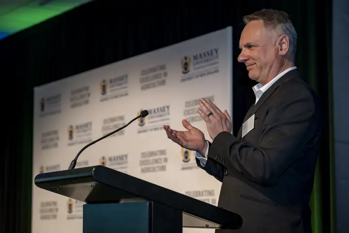 Massey University Vice-Chancellor Professor Pierre Venter applauding at the Agriculture Awards ceremony.