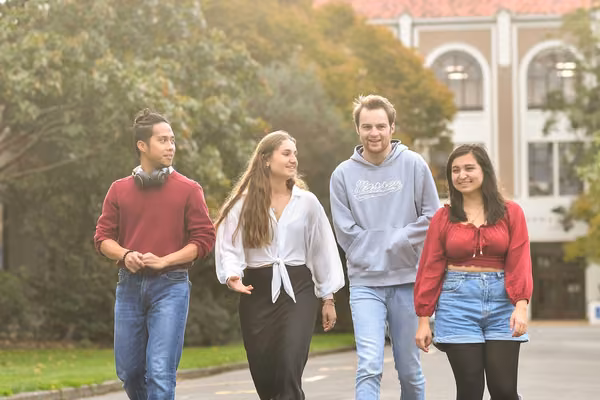 Four students walking on campus