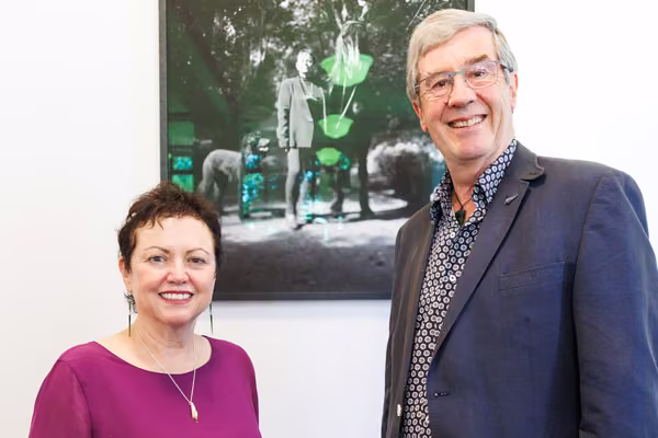 Vice-Chancellor Professor Jan Thomas and Chancellor Alistair Davis in front of the portrait by photographer Sara Tautuku Orme.