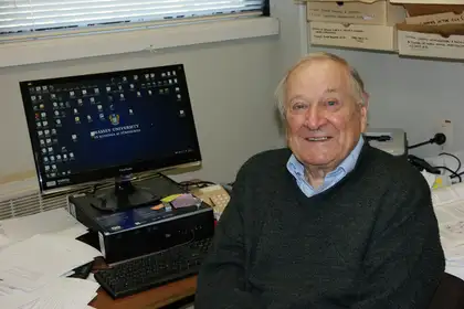 elderly man sitting at a computer desk