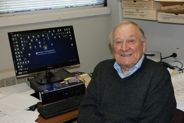 elderly man sitting at a computer desk