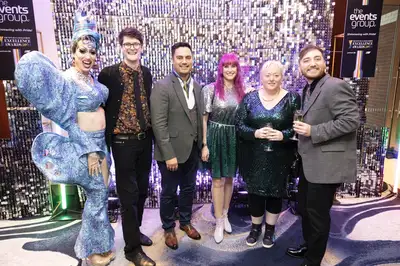 6 people standing together celebrating at the Rainbow Excellence Awards