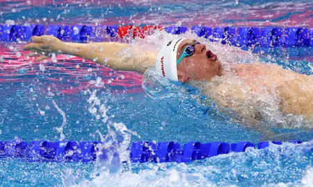 Man swimming backstroke in a pool