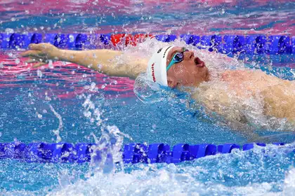 Man swimming backstroke in a pool