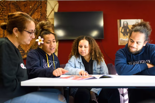 Pacific students around a table