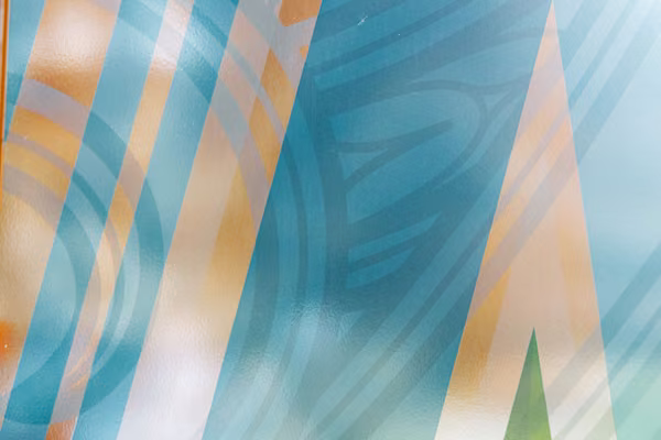 Abstract window artwork featuring blue, orange and green geometric patterns.
