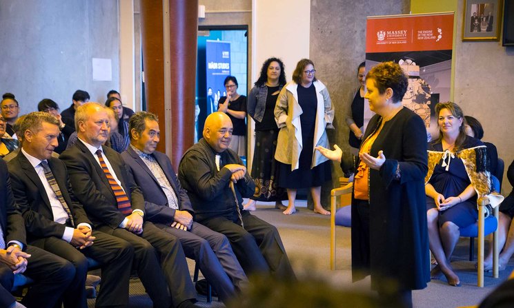 Massey University VC, Professor Jan Thomas speaking to a seated group about what happens at a pōwhiri