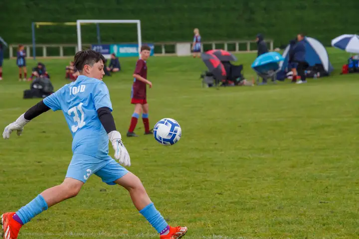 boy kicking football