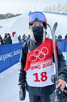 Chloe McMillan holding her skis