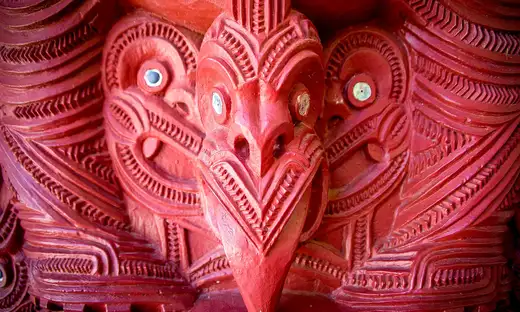 Close-up of red traditional Māori wood carving at a marae