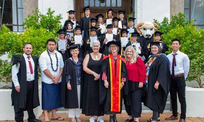 Image of children and academic staff in graduation gowns